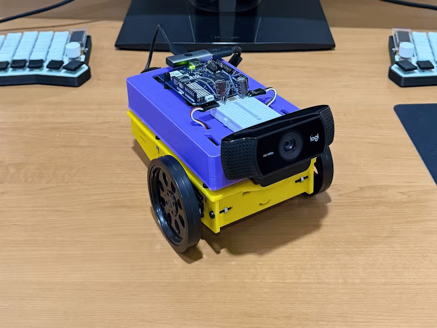Photo of the face-following robot built with Arduino UNO Q, showing the webcam and servomotors